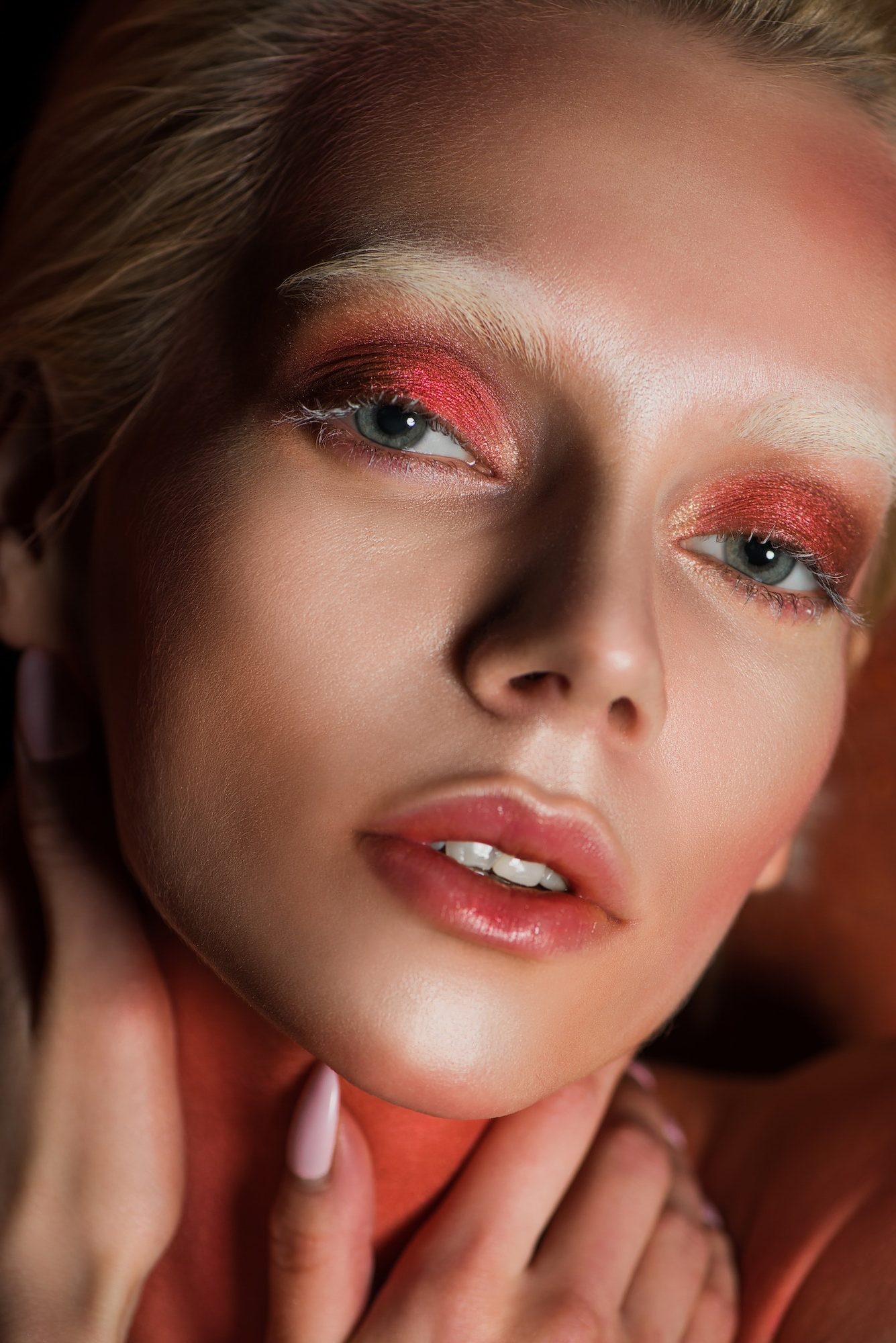 sensual woman with red makeup looking at camera e1682493402432